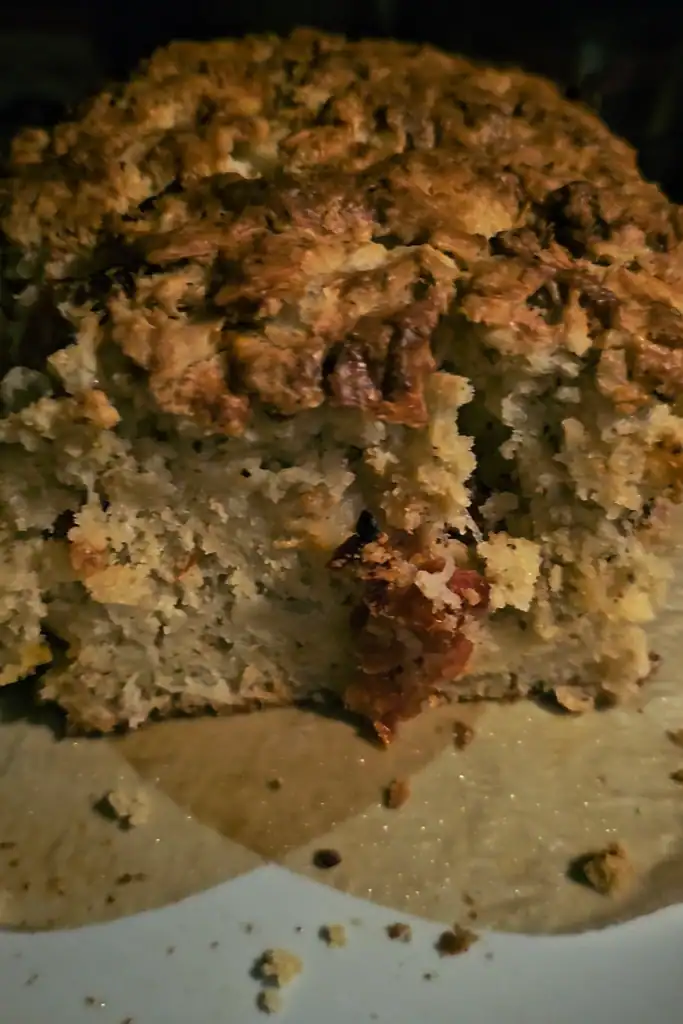 Inside of a cut herb and sundried tomato bread