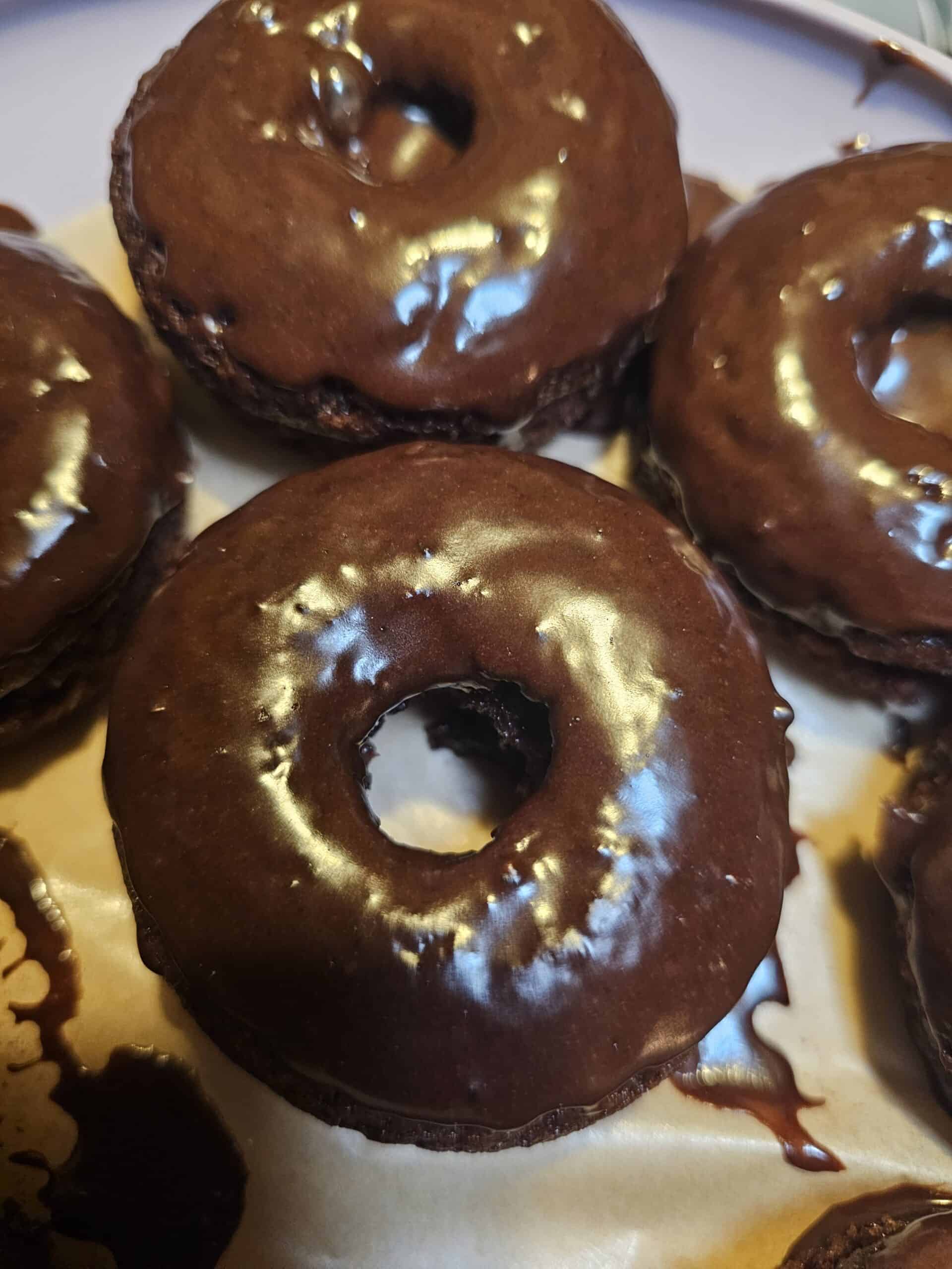 Baked chocolate buttermilk donuts with chocolate glaze on a plate