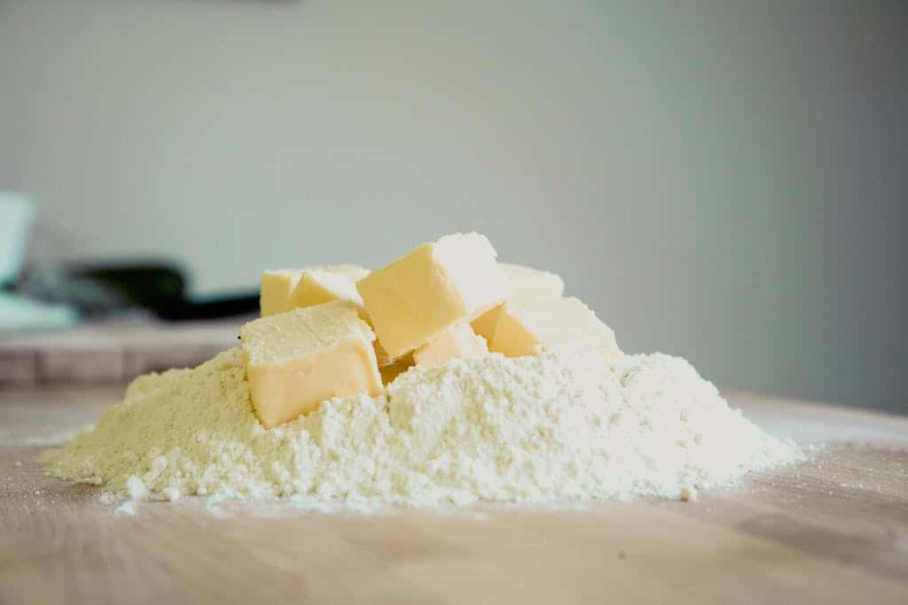 Close-up of butter and flour on a kitchen counter, perfect for baking.