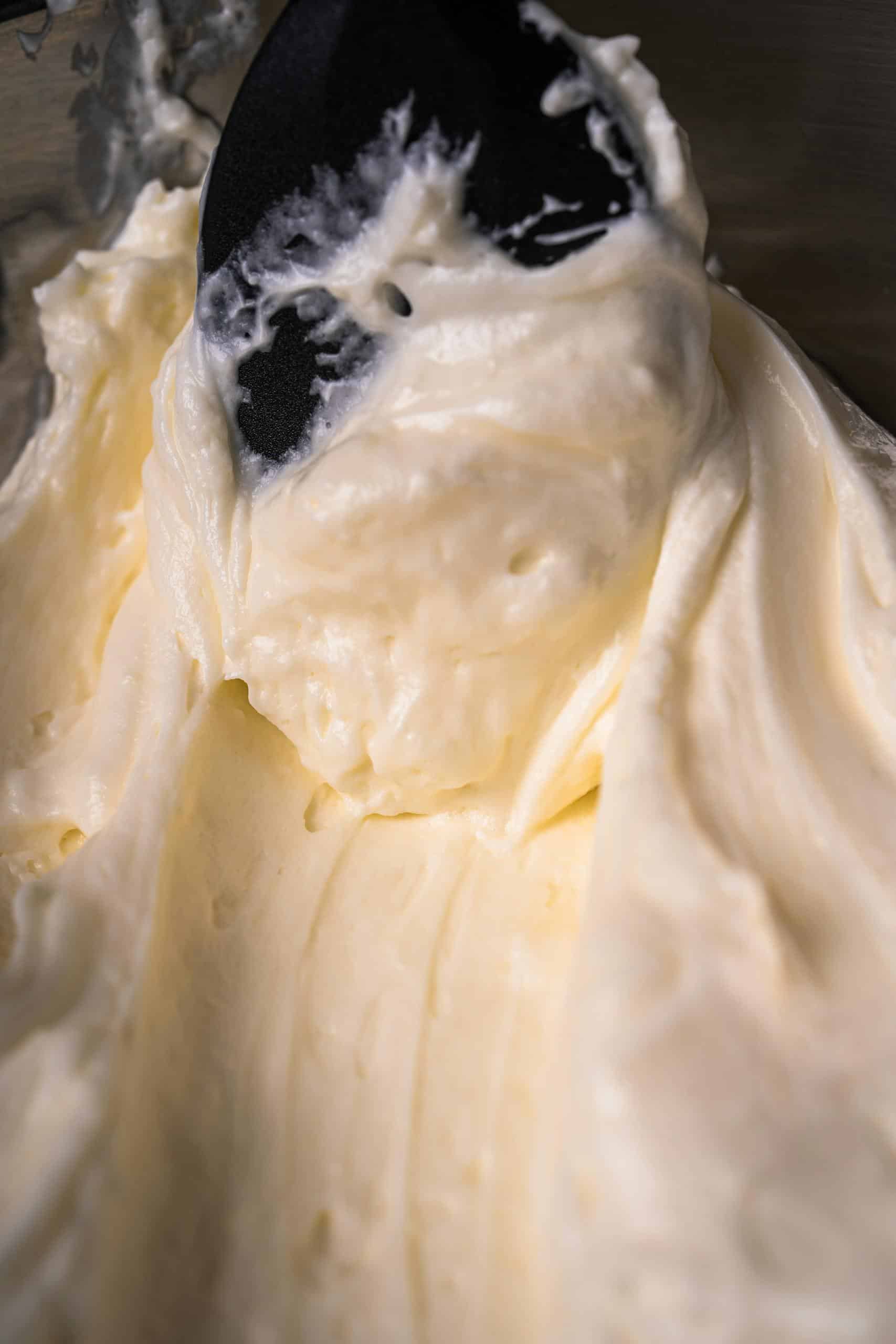 Rich, creamy homemade vanilla buttercream frosting smoothly spread with a spatula.