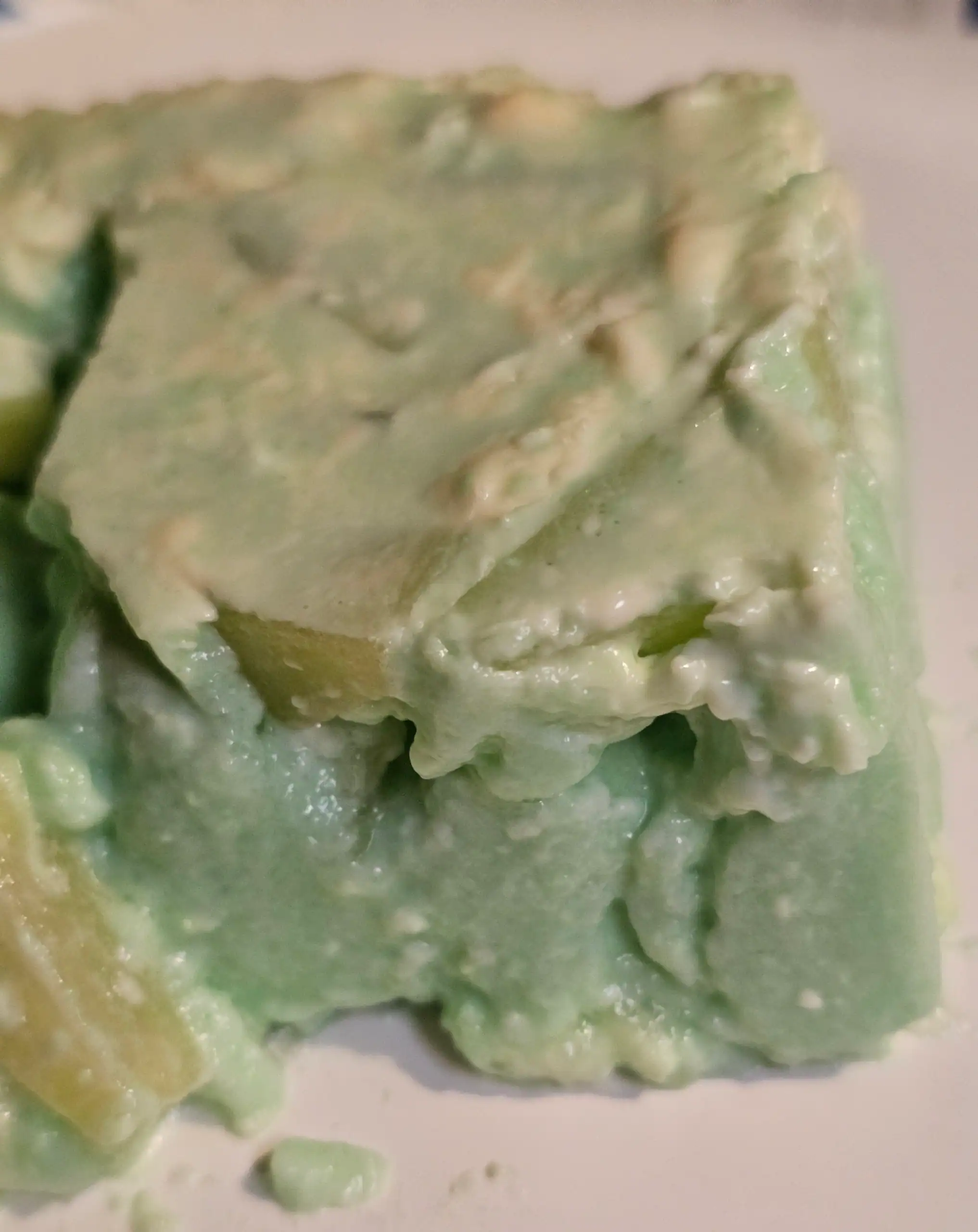 Slice of green jello salad on plate