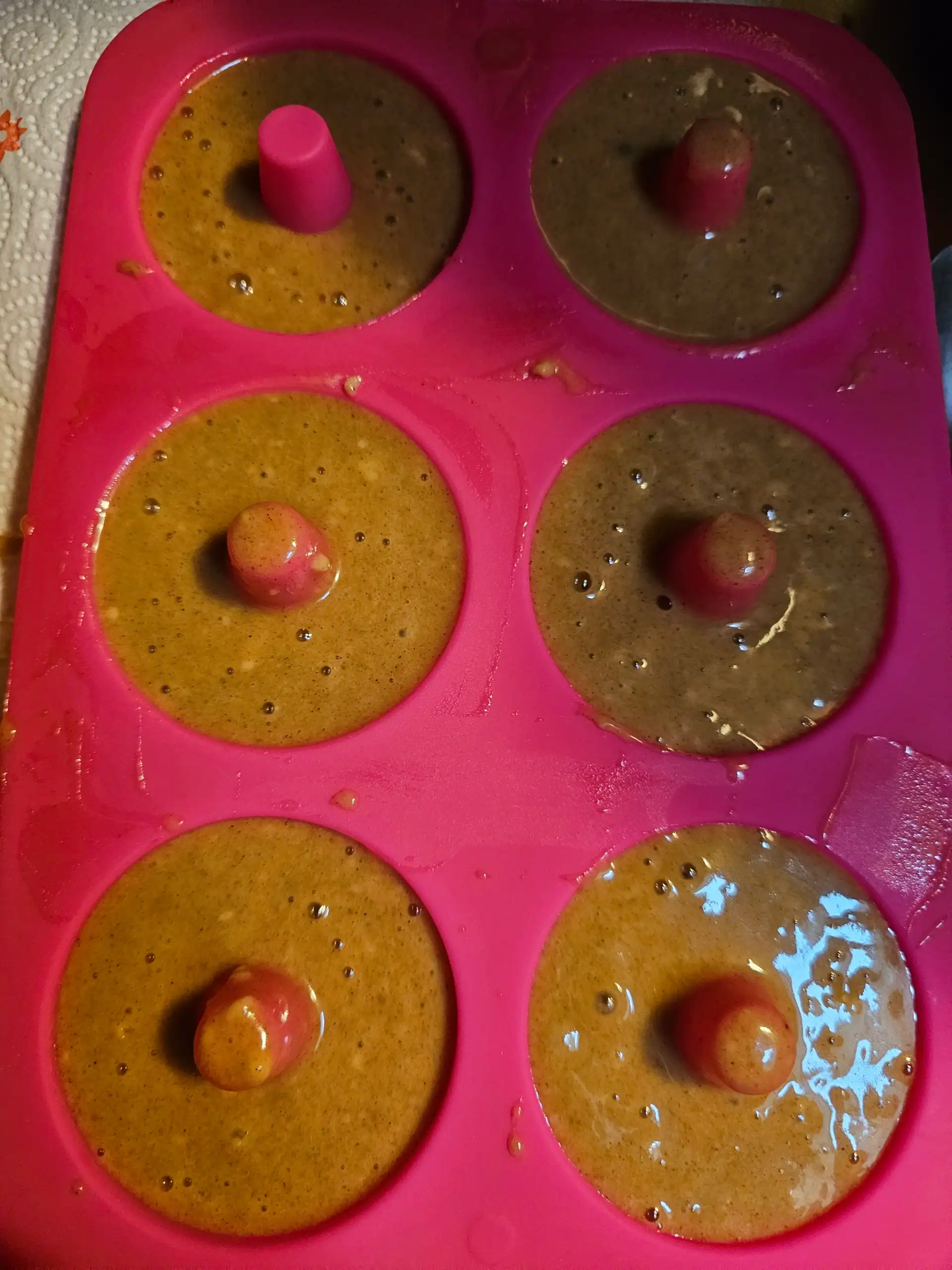 Baked apple cider donut batter in silicone pan before baking