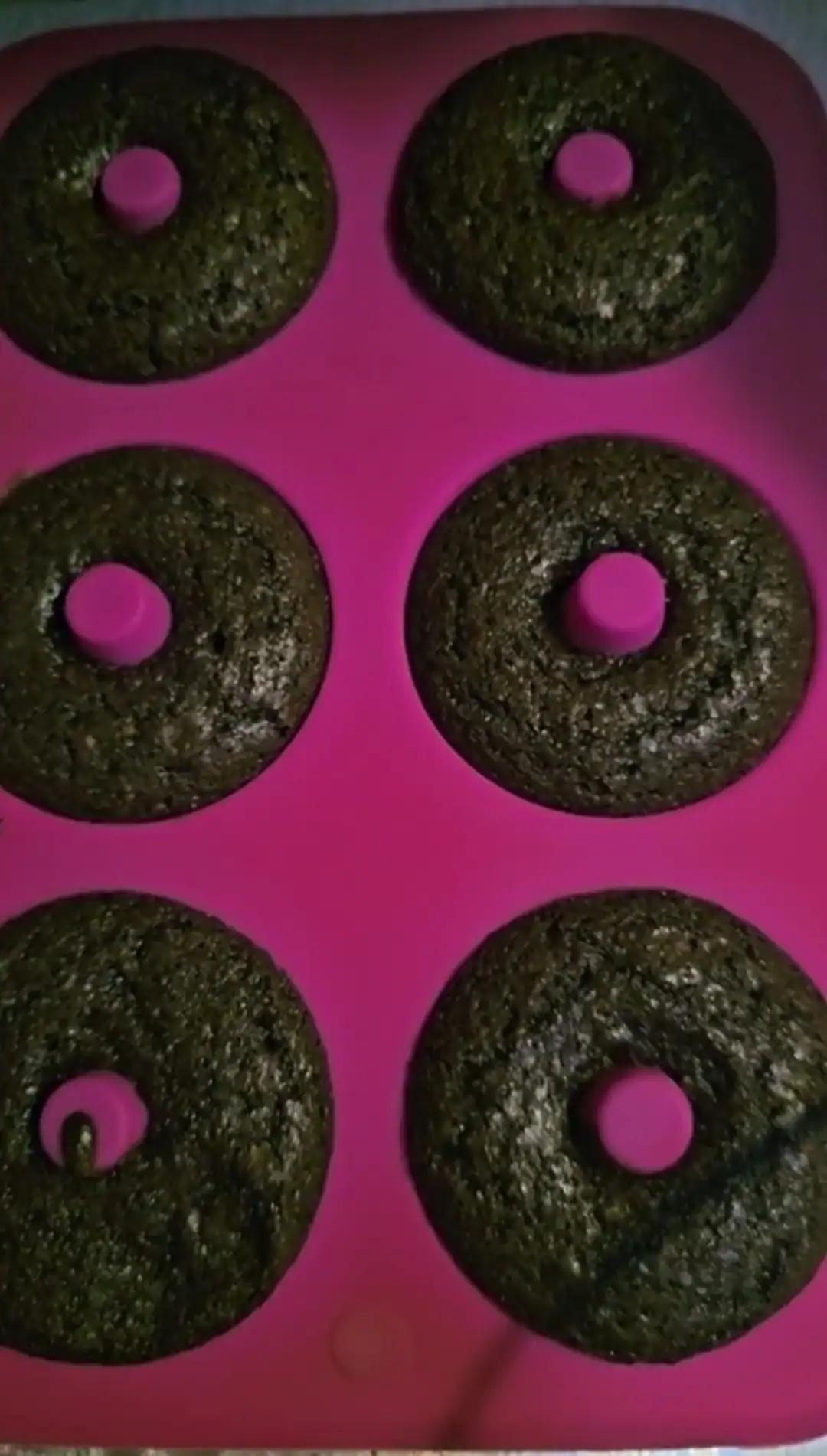 Baked chocolate buttermilk donuts in silicone pan after being baked